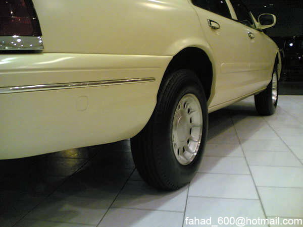 Cream sedan rear quarter panel and wheel