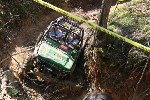 1992 Ford Bronco - This buggy is tackling a challenging off-road course, with caution tape indicating the boundaries of the trail.