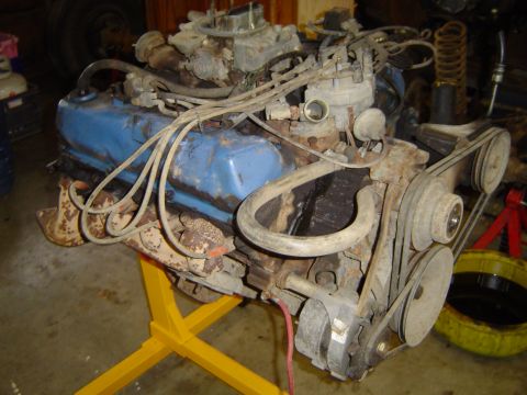 1979 Ford Bronco - V8 engine assembly on an engine stand, with various hoses and belts visible.