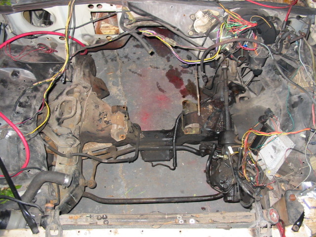 Exposed engine bay with wiring harness and transmission components