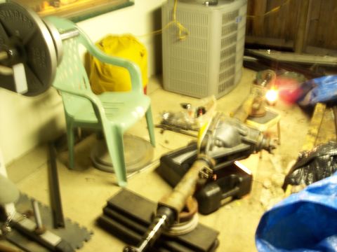 1988 Ford Bronco - A differential assembly with a driveshaft is shown on the floor.