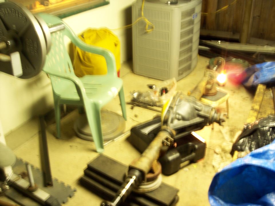 Differential assembly with driveshaft attached, resting on blocks