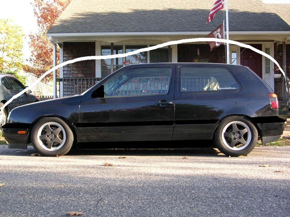 Black Volkswagen Golf Mk3 parked on street, side view