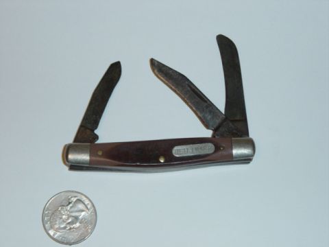 1988 Ford Bronco - Pocket knife with three open blades sits next to a quarter.