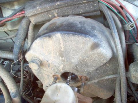 1988 Ford Bronco - The brake booster assembly is covered in dust and grime, with various hoses and wires surrounding it.