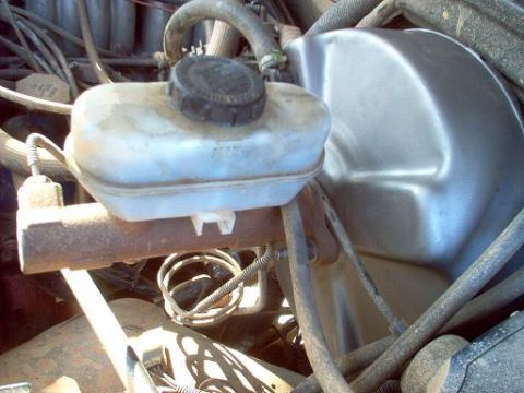1988 Ford Bronco - Close-up of a brake master cylinder and booster, likely from an older vehicle.