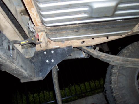 1994 Ford F-150 - Underside view of a 1994 Ford F-150, focusing on the rear suspension and fuel tank mounting.