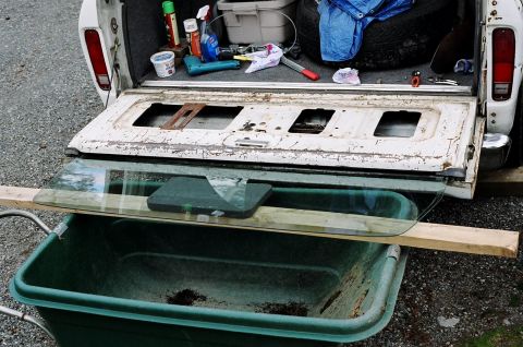 1979 Ford Bronco - Glass extended and supported. Now to reattach the retractor arm to the plastic wheel in the metal channel.