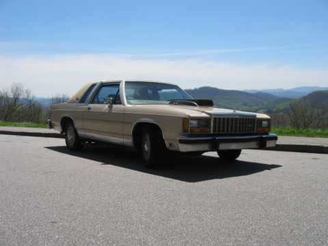 1985 Ford LTD Crown Victoria - This two-door coupe has a distinctive hood scoop and a vinyl roof.