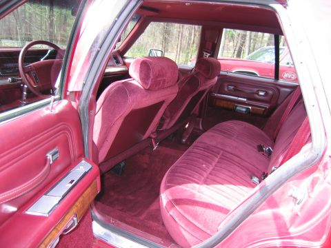 1991 Ford LTD Crown Victoria - Interior view of a 1991 Ford Crown Victoria LTD, red velour upholstery and wood trim accents.