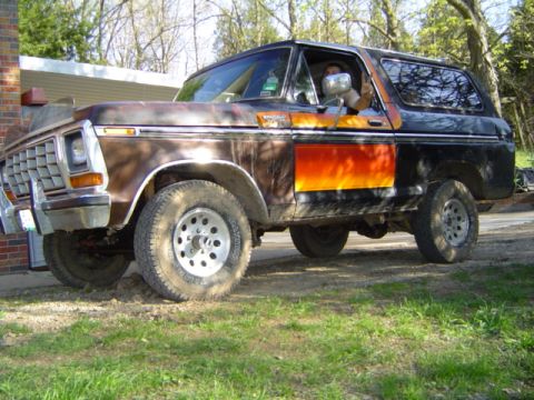 1979 Ford Bronco - This 1978 Ford Bronco features a distinctive two-tone paint scheme with orange and black graphics.