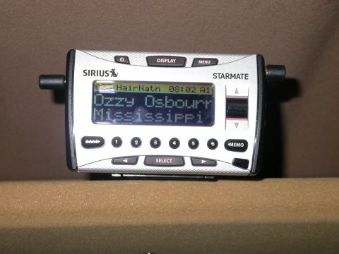 1990 Ford Bronco - Sirius satelite radio receiver mounted to my shelf. The display is actually red, it just looks green due to the flash.
