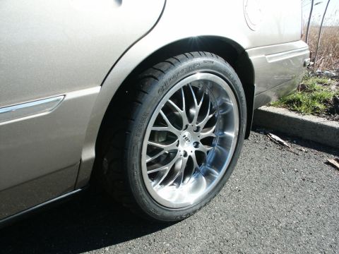 2001 Mercury Grand Marquis - Rear passenger side view of a 2001 Mercury Grand Marquis with custom chrome wheels.