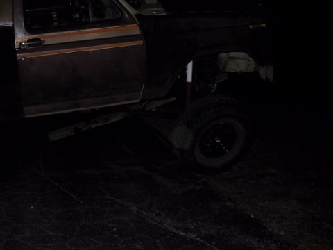 1983 Ford Bronco - This lifted Ford Bronco appears to be modified for off-road use, with its suspension and tires clearly visible.