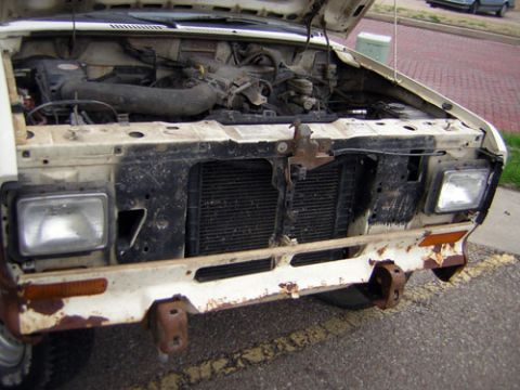 1986 Ford Bronco II - Front view of a 1986 Ford Bronco II with the hood open, revealing the engine and grille.
