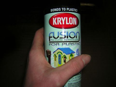 1986 Ford Bronco II - A hand holds a can of Krylon Fusion for Plastic spray paint, which features a graphic of a small house.
