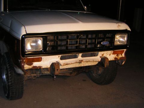 1986 Ford Bronco II - The front grille and bumper of a 1986 Ford Bronco II show signs of rust and wear.