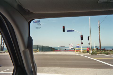 1990 Ford Bronco - View through a windshield of a coastal road intersection with a Vista Del Mar street sign and ocean ships in the distance.
