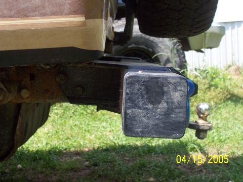 1987 Ford Bronco - The rear bumper and trailer hitch assembly are visible, along with a spare tire mounted above.