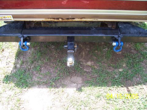 1987 Ford Bronco - Aftermarket rear bumper assembly with tow hitch and blue D-ring recovery points installed.