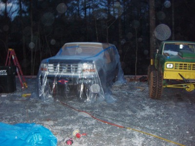 1995 Ford C-350 (Centurion Conversions) - The truck covered w/ paper near the paint surfaces and further away with some thin plastic.