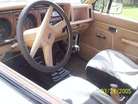 1984 Ford Bronco II - The interior of an older vehicle is shown, a tan dashboard and seats, with a date stamp from 2005.