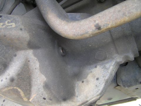 2000 Ford Excursion - Close-up view of a vehicle's differential housing, showing the fill and drain plugs.