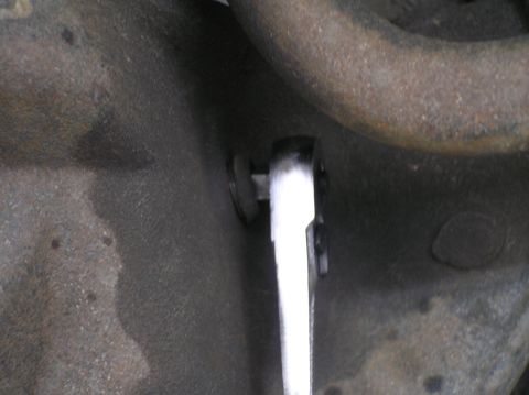 2000 Ford Excursion - A wrench is used to remove a plug from a vehicle's differential housing.