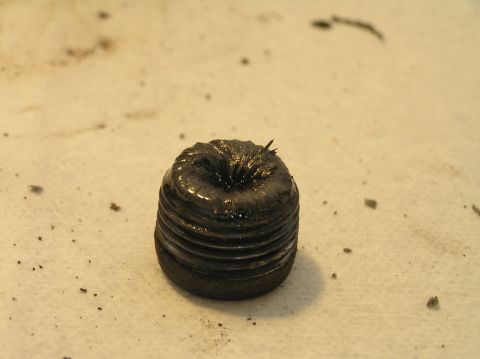 2000 Ford Excursion - A magnetic drain plug shows significant metal particulate, indicating potential wear within the differential.