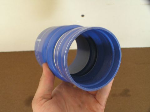 2000 Ford Excursion - A blue silicone hose is held in a hand, showing its ribbed interior and smooth exterior.