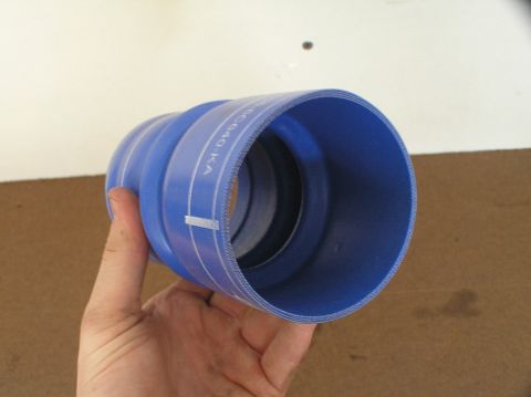 2000 Ford Excursion - A blue silicone hose, likely a CAC hose, is held in a hand. White markings and text are visible on the hose.