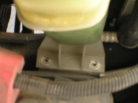 2000 Ford Excursion - Plastic bracket with mounting holes, likely part of an engine component assembly.