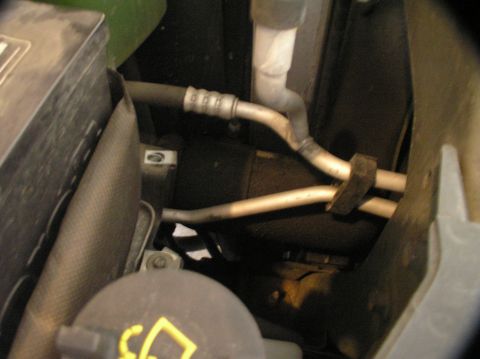 2000 Ford Excursion - Close-up view of AC hoses and engine components within a 2000 Ford Excursion.