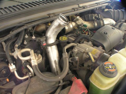2000 Ford Excursion - Close-up view of a diesel engine's intake system, showing a large intercooler pipe.