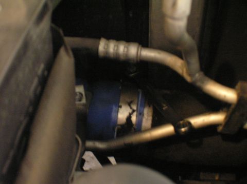 2000 Ford Excursion - Close-up view of a damaged engine hose and a blue component, likely part of the CAC system.