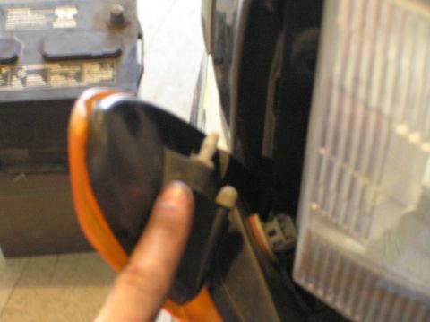 2000 Ford Excursion - Close-up of a vehicle's front lighting system, focusing on the parking light removal process.