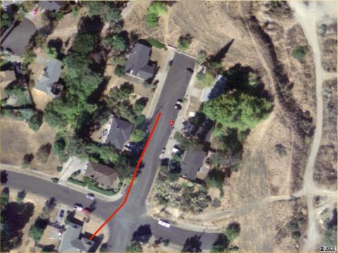 2000 Ford Ranger - An aerial perspective captures a quiet suburban street lined with homes and several vehicles parked along the roadside.