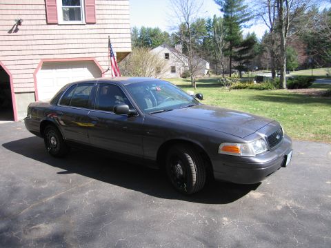 1991 Ford LTD Crown Victoria - This Ford Crown Victoria, likely a later model, is parked outside a suburban home on a sunny day.