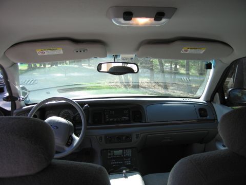 1991 Ford LTD Crown Victoria - The interior of a 1991 Ford Crown Victoria LTD, its dashboard, steering wheel, and seating areas.