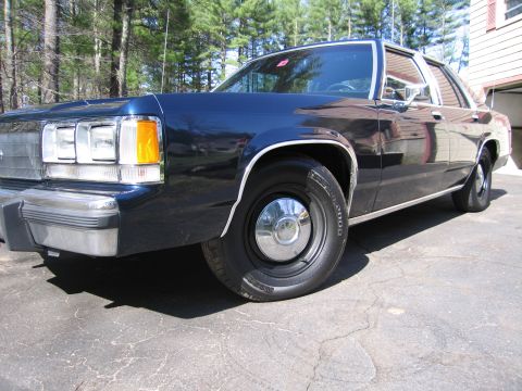 1991 Ford LTD Crown Victoria - This dark blue sedan's body style suggests a model year in the 1980s, not 1991.