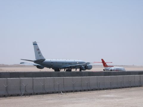 1988 Ford Bronco - Two aircraft are visible on the tarmac of an airfield under a clear sky.