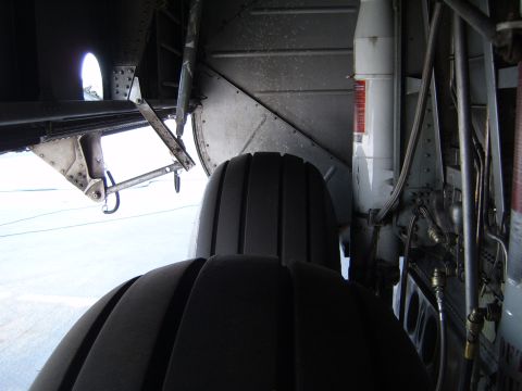 1988 Ford Bronco - Close-up view of complex aircraft landing gear components and a large tire.