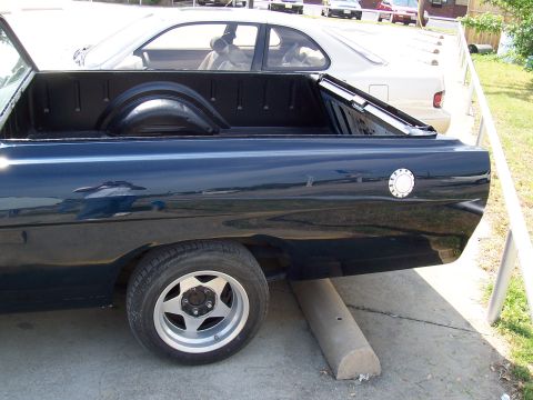 1969 Ford Ranchero - Rear view of a dark blue 1969 Ford Ranchero pickup, aftermarket wheels and a clean bed.