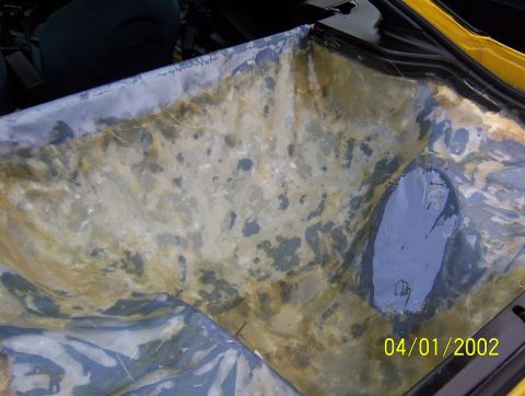 1994 Ford Probe - Interior view of a yellow car with visible damage to the lining and a dark patch.