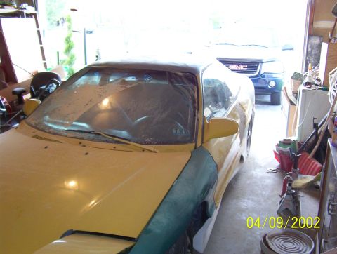 1994 Ford Probe - A yellow car is parked in a garage, with another vehicle behind it. The date 04/09/2002 is visible.