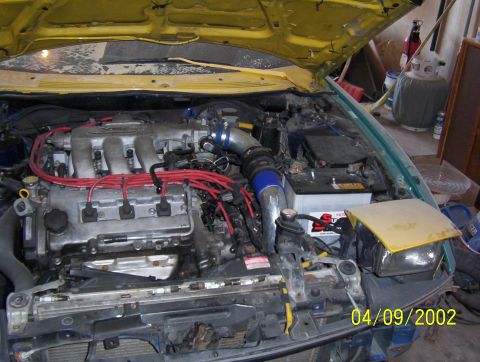 1994 Ford Probe - Car engine bay with V6 engine and visible components. Date stamp indicates photo taken in 2002.