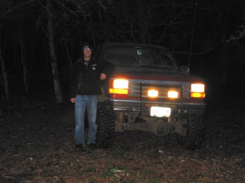 1991 Ford Explorer - Man poses with his 1991 Ford Explorer in a wooded area at night.