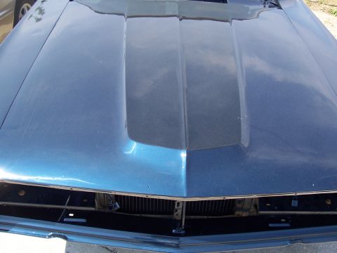 1969 Ford Ranchero - The grille and hood of a blue 1969 Ford Ranchero are visible from the front.