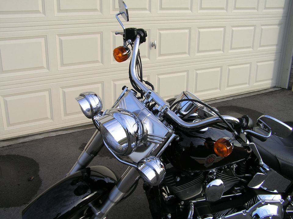 Black Harley-Davidson Fat Boy front detail with chrome headlight and amber turn signals