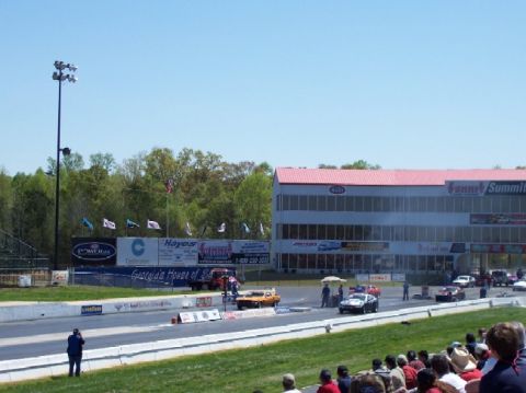1978 Ford F-250 - A drag racing event is underway with multiple vehicles on the track and spectators in the stands.